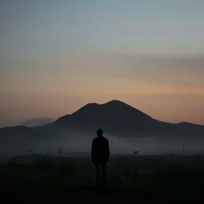 Person at Juba at Sunset with Foggy Mountain