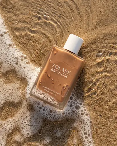 Ultra realistic beach photography for a bronzer bottle product shot