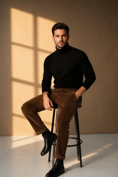 Golden hour studio portrait of a man in turtleneck and corduroy