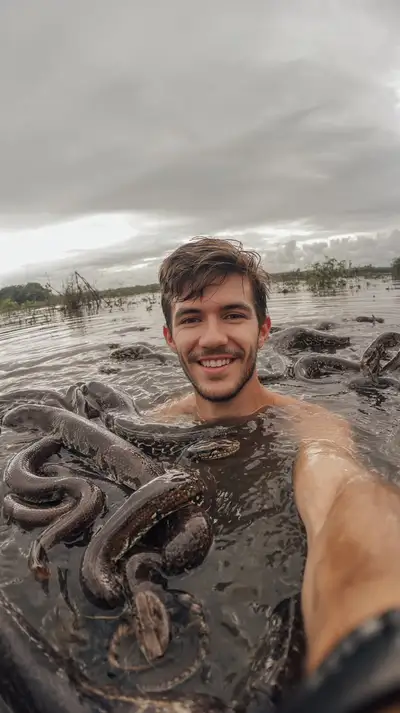 Gen Z Blogger Swimming with Anacondas