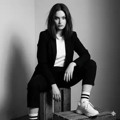 Black-and-white editorial portrait on wooden crates