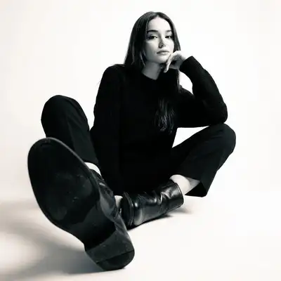 High-contrast black and white studio floor portrait