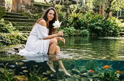 Serene Woman by a Lotus Pond with Underwater Scene