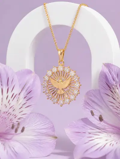 Gold dove pendant jewelry photography with lily blossoms