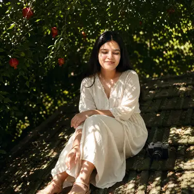 Identity-preserving rooftop portrait with pomegranates and camera