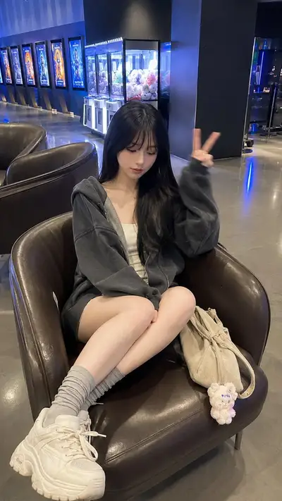 Cinematic Lifestyle Photo Prompt: Young Woman in Cinema Lobby