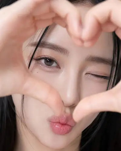 JSON-structured close-up selfie with heart-shaped hands