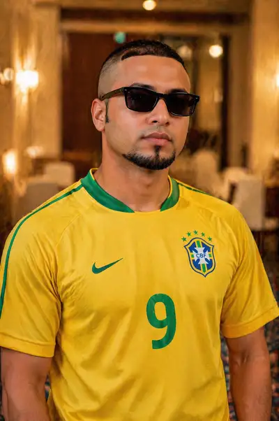 South Asian man portrait in vintage Brazil jersey