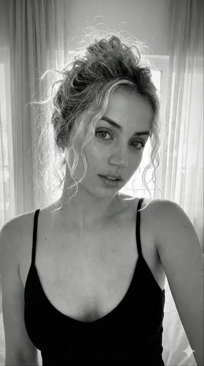 Candid black-and-white close-up selfie-style portrait by a window