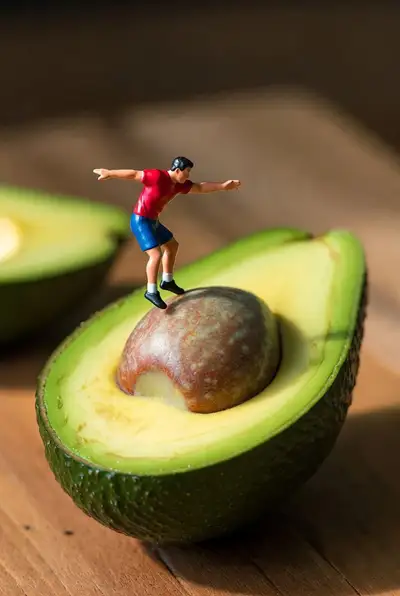 Surreal Miniature Diver Jumping into Avocado Pool