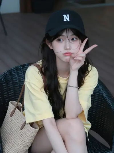 Resort-style portrait of a young woman in a black baseball cap