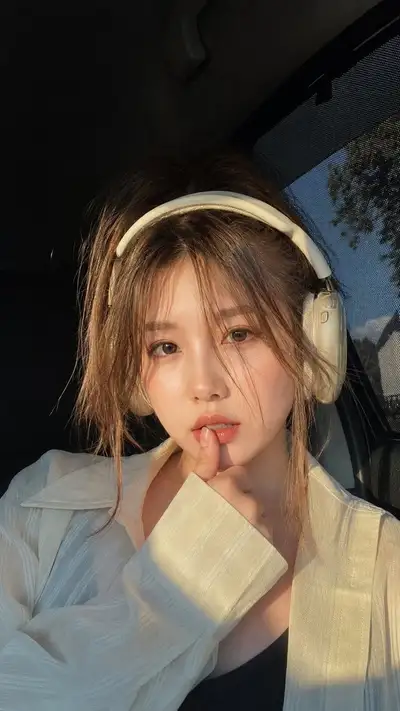 Golden hour car portrait of a woman wearing cream headphones