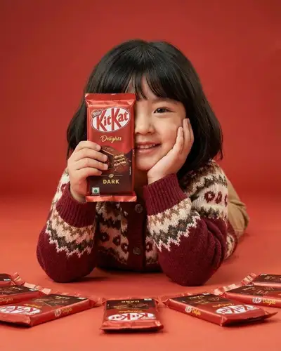 Girl with a KitKat chocolate bar in a red studio ad