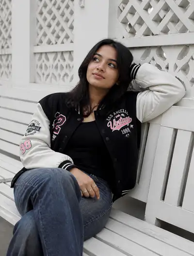 Casual Portrait on White Bench with Varsity Jacket