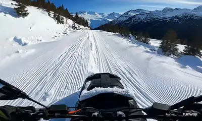 POV Snowmobile Rider on Snowy Mountain Road