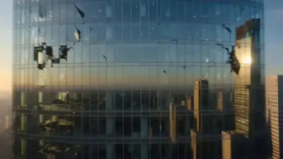 FPV dive through a collapsing glass tower revealing text
