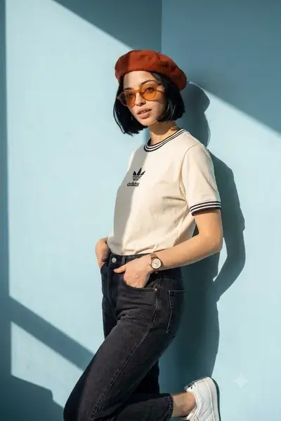 Minimalist fashion editorial portrait against pastel wall
