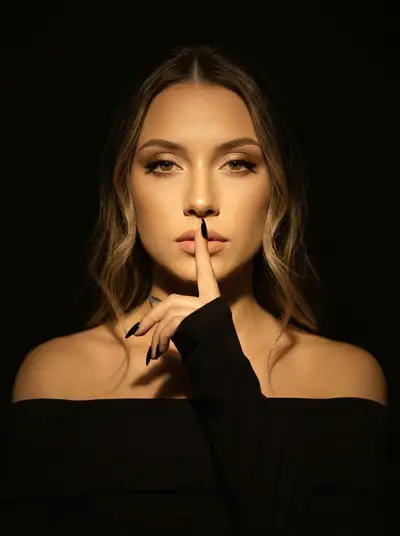 Dramatic Low-Key Studio Portrait with Golden Spotlight