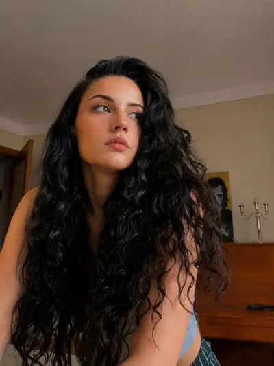 Dreamy Cinematic Portrait with Voluminous Raven Curls