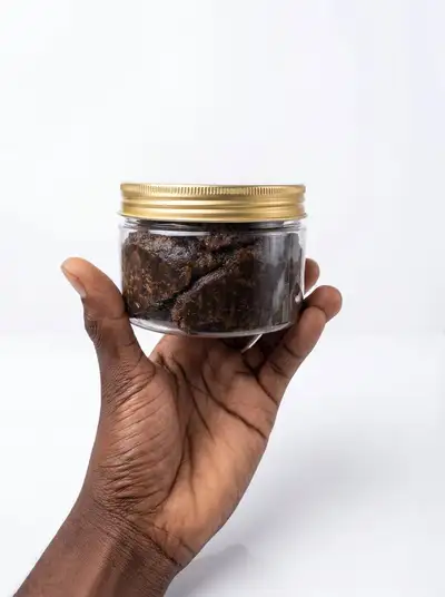 Clean studio product photo edit of an African black soap jar