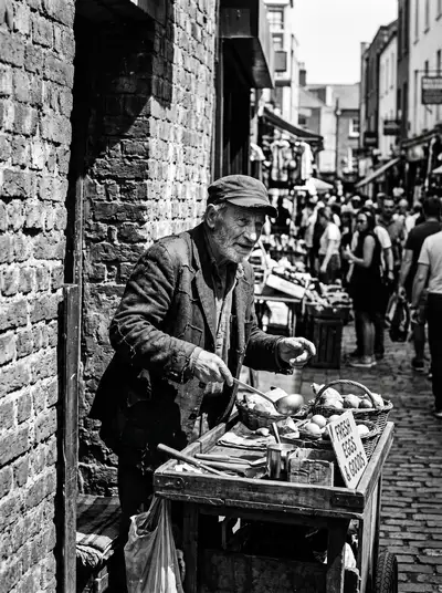 Candid black and white street vendor portrait