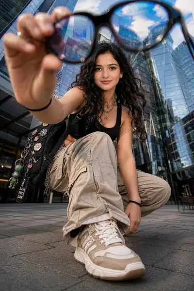 Low-angle street fashion shot in futuristic glass plaza