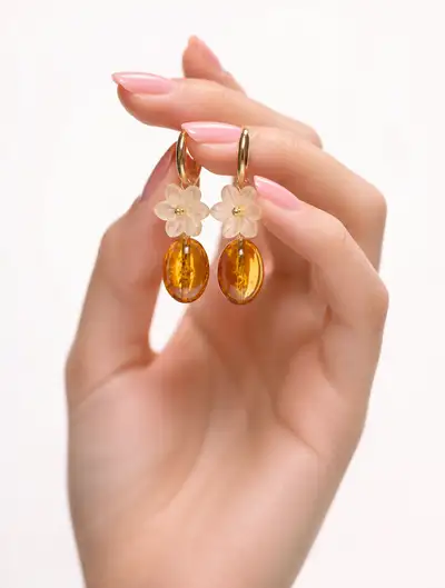 Gold ring earrings pinched between fingertips