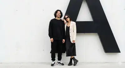 Couple's Fashion Portrait with Abstract 'A' Background