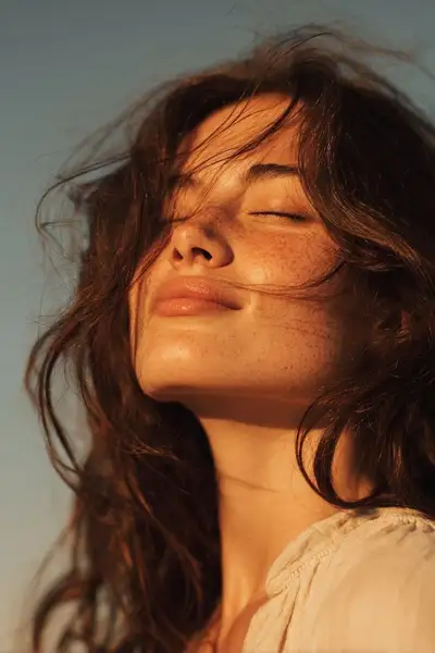 Golden hour close-up portrait with windblown hair