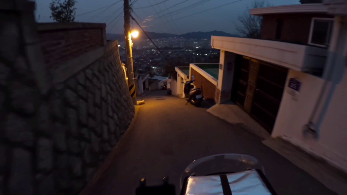 Motorbike delivery dash through a Korean hillside at dusk (Seedance 2.0)