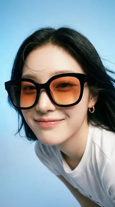 Playful high-fashion portrait with orange lens sunglasses