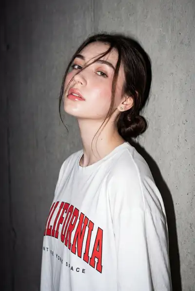 Flash-lit editorial portrait against concrete wall