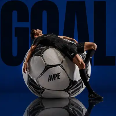 Dramatic Sports Editorial Footballer on Oversized Ball