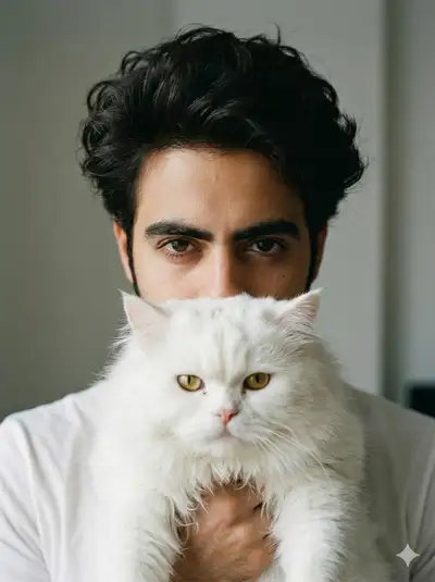 Close-up portrait of a man holding a fluffy Persian cat