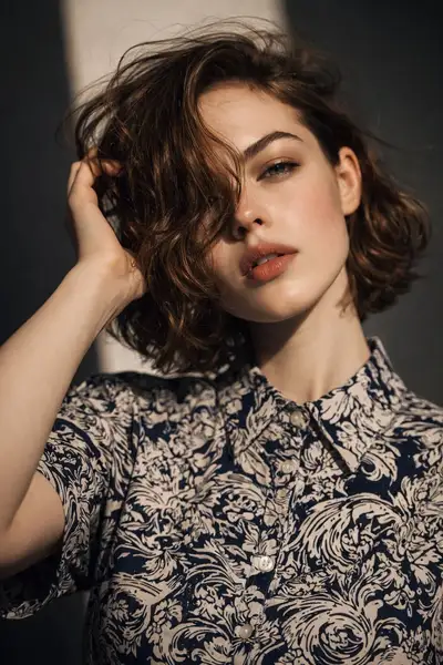 Editorial close-up portrait in a floral button-up shirt