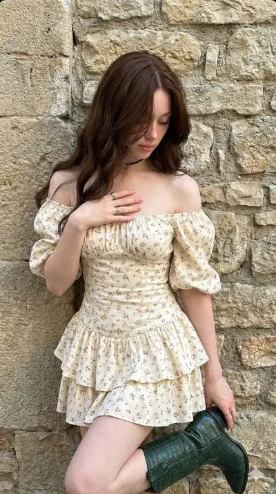 Boho floral mini dress portrait against stone wall