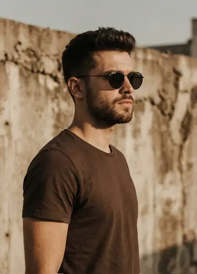 Golden-hour side-profile portrait against a textured concrete wall