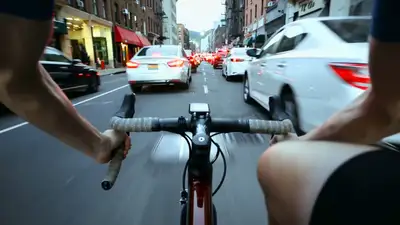 First-Person Urban Cycling Through Traffic