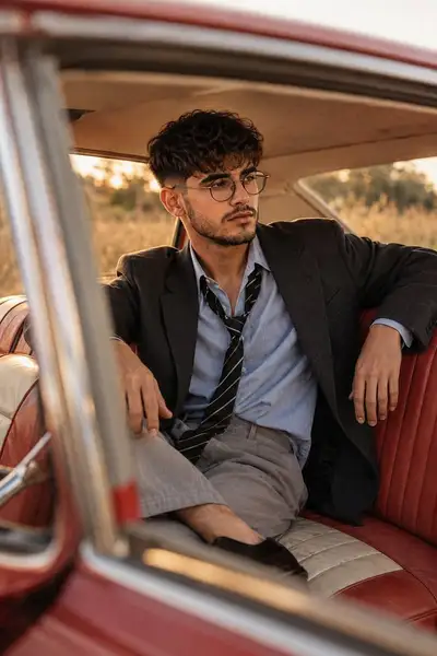 Vintage red car lifestyle portrait at golden hour