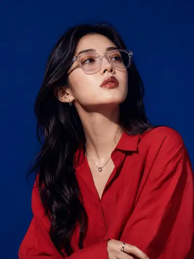 Luxury eyewear campaign portrait of woman in red silk blouse