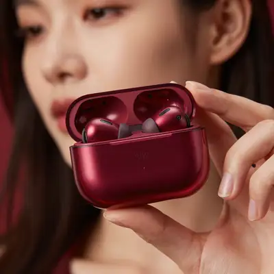Macro product shot of a transparent maroon wireless earbuds case