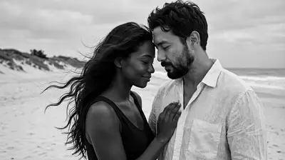 Black and white cinematic portrait of a couple on a windswept beach