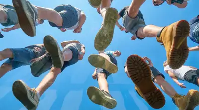 View from beneath transparent plexiglass of people walking
