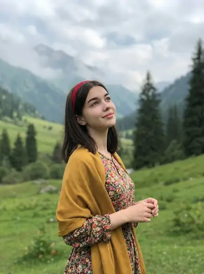 Lifestyle portrait of a woman in a green mountain valley