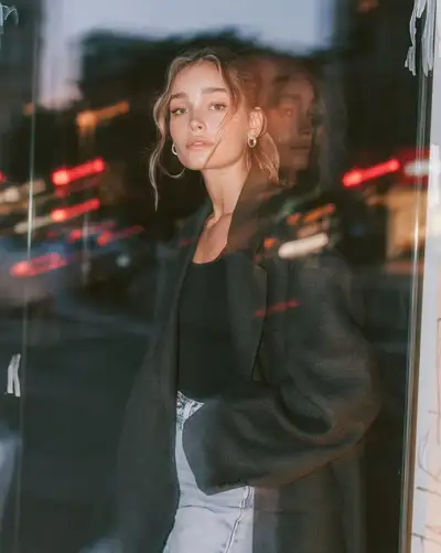 Editorial fashion portrait at blue hour with glass reflections
