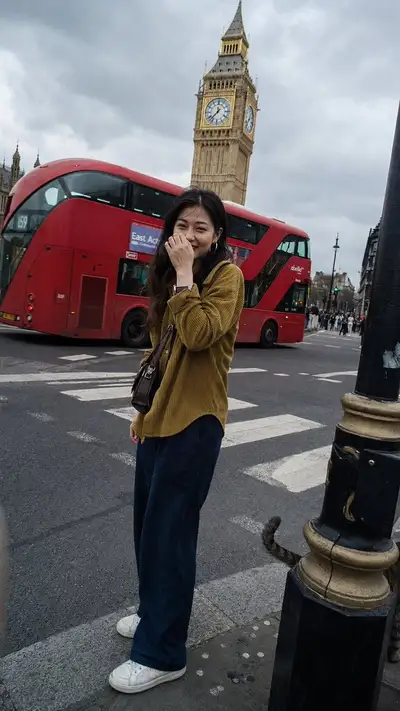 Candid London street photo with film grain, Big Ben backdrop