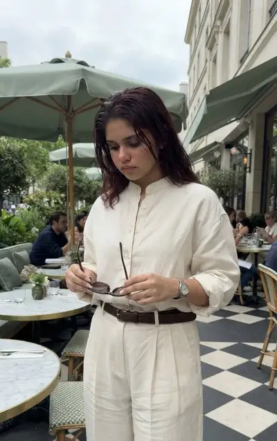Ultra-Realistic Candid Café Photo of Woman Folding Sunglasses
