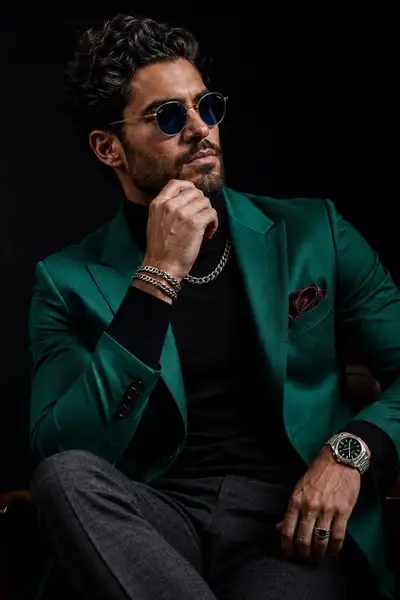 Luxury menswear editorial portrait in emerald tailored blazer