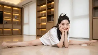 Glamorous idol portrait doing a floor split in a living room