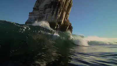 Cinematic Wave-Height Camera Orbit Through Limestone Arch